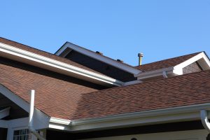 new brown asphalt shingle roof on a house